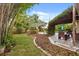 Landscaped backyard featuring a pool, multiple seating areas, and lush greenery, creating a private retreat at 1135 Thunder Trl, Maitland, FL 32751