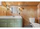Bathroom with decorative wooden walls, white counters, and vintage lighting fixtures at 1135 Thunder Trl, Maitland, FL 32751