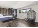 Stylish bedroom with built-in bed, dark wood floors, modern shelving, and an egg chair near a window at 1135 Thunder Trl, Maitland, FL 32751