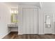 A bright bedroom with a large closet, vanity, and a modern white and natural wood design at 1135 Thunder Trl, Maitland, FL 32751