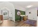 Charming bedroom features hardwood floors, a bright window seat, and a unique green accent wall at 1135 Thunder Trl, Maitland, FL 32751