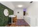 Cozy bedroom boasts hardwood floors, recessed lighting, and a distinctive faux ivy accent wall at 1135 Thunder Trl, Maitland, FL 32751