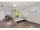 Spacious bedroom features hardwood floors, natural light, and a quirky green wall at 1135 Thunder Trl, Maitland, FL 32751