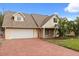 An inviting single-Gathering home with a brick driveway, lush lawn, and stylish architectural details at 1135 Thunder Trl, Maitland, FL 32751