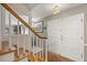 Home's foyer features wood stairs and a white door with brick flooring at 1135 Thunder Trl, Maitland, FL 32751