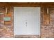 A welcoming double front door with brick surround, modern sconces, and a unique address display at 1135 Thunder Trl, Maitland, FL 32751