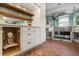 Charming kitchen showcasing white cabinets, stainless steel appliances, and brick flooring at 1135 Thunder Trl, Maitland, FL 32751