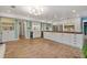 Spacious kitchen boasts brick flooring, white cabinetry, stainless steel appliances, and a large center island at 1135 Thunder Trl, Maitland, FL 32751
