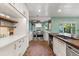 This spacious kitchen boasts custom cabinetry, a large stainless steel range and brick flooring throughout at 1135 Thunder Trl, Maitland, FL 32751