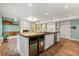 Open concept kitchen island with stainless steel appliances, wood countertops, and brick flooring at 1135 Thunder Trl, Maitland, FL 32751