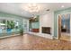 Bright living room with whitewashed brick fireplace and views of the outdoor pool area at 1135 Thunder Trl, Maitland, FL 32751