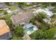 Aerial view of a beautiful pool and patio surrounded by lush greenery and landscaping at 1135 Thunder Trl, Maitland, FL 32751
