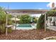Landscaped backyard featuring a pool, patio, and pergola covered in vines, creating a private oasis at 1135 Thunder Trl, Maitland, FL 32751