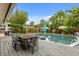 Outdoor pool and patio area with a wooden dining table and chairs, perfect for outdoor entertaining at 1135 Thunder Trl, Maitland, FL 32751