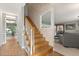 Staircase with wood railings and a glimpse into the living room at 1135 Thunder Trl, Maitland, FL 32751
