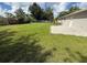 The backyard features green grass and access to the home via a brick patio at 1139 Poppy Ave, Orlando, FL 32811