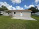 A well-maintained backyard features a concrete patio and access to the home's back door at 1139 Poppy Ave, Orlando, FL 32811