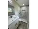 Bathroom with a shower, vanity with granite counters and wood-look flooring at 1139 Poppy Ave, Orlando, FL 32811