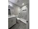 Modern bathroom with tiled shower, gray floors, and white vanity at 1139 Poppy Ave, Orlando, FL 32811