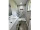 Bathroom with shower, white cabinets, modern vanity, and gray tile at 1139 Poppy Ave, Orlando, FL 32811