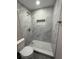 Tiled shower with built-in niche in remodeled bathroom at 1139 Poppy Ave, Orlando, FL 32811