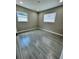 Cozy bedroom featuring gray walls, recessed lights, and modern floors with natural light from two windows at 1139 Poppy Ave, Orlando, FL 32811