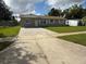 Charming single-story home with a well-manicured front yard and paved driveway at 1139 Poppy Ave, Orlando, FL 32811