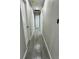 Clean hallway with neutral walls and contemporary wood-look tile, leading to various rooms in the home at 1139 Poppy Ave, Orlando, FL 32811