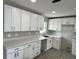 Newly renovated kitchen with modern white cabinets, light countertops, and recessed lighting fixtures at 1139 Poppy Ave, Orlando, FL 32811