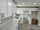 Bright kitchen featuring white cabinets, stainless steel hardware, and a spacious counter area for cooking at 1139 Poppy Ave, Orlando, FL 32811