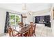 Inviting dining room showcasing ample natural light, a wooden dining table, and views of the living area at 1221 N Brickell Dr, Deltona, FL 32725