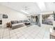 Spacious living room featuring vaulted ceilings, sky lights, tile floors, and sliding glass doors to the patio at 1221 N Brickell Dr, Deltona, FL 32725