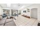 Bright living room featuring tile flooring, sky lights, a comfortable sofa, and access to outdoor patio at 1221 N Brickell Dr, Deltona, FL 32725