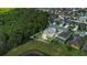 Aerial shot of home with expansive lot in wooded neighborhood, complete with outdoor living area at 15659 Carina Dr, Orlando, FL 32828