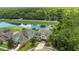 An aerial view of a well-landscaped yard, showcasing a pristine neighborhood setting, and a backyard pond at 15659 Carina Dr, Orlando, FL 32828