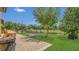 Outdoor area boasting a brick-paved patio, well-maintained lawn, and serene views of the adjacent pond at 15659 Carina Dr, Orlando, FL 32828