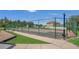 Community basketball court for recreational games featuring a fenced perimeter and concrete sideline for spectators at 15659 Carina Dr, Orlando, FL 32828