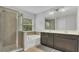 Bathroom featuring double vanity, tub, and glass-enclosed shower at 15659 Carina Dr, Orlando, FL 32828