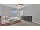 Comfortable bedroom with two windows and a sleek black dresser, creating a relaxing space at 15659 Carina Dr, Orlando, FL 32828