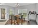 This dining area features a table with four chairs and is lit by a modern chandelier at 15659 Carina Dr, Orlando, FL 32828