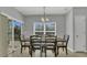 Dining room with wood table and chairs, complemented by natural light at 15659 Carina Dr, Orlando, FL 32828