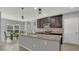 Modern kitchen with stainless steel appliances, dark cabinetry, and a center island at 15659 Carina Dr, Orlando, FL 32828