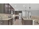 Modern kitchen with stainless steel appliances, dark cabinetry, and a center island at 15659 Carina Dr, Orlando, FL 32828