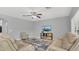 Cozy living room with plush seating, patterned rug, and a ceiling fan at 15659 Carina Dr, Orlando, FL 32828
