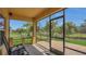 Screened in patio perfect for outdoor relaxation, overlooking the backyard and peaceful waterfront views at 15659 Carina Dr, Orlando, FL 32828