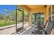 Relaxing screened patio featuring comfortable lounge chairs and an outdoor view to a manicured lawn at 15659 Carina Dr, Orlando, FL 32828