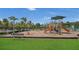 Community playground features swings, slides, and climbing structures for hours of outdoor fun on mulch with plenty of seating nearby at 15659 Carina Dr, Orlando, FL 32828