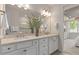 Elegant bathroom with double vanity, quartz countertop, framed mirror, and neutral color palette at 1811 Spring Shower Cir, Kissimmee, FL 34744