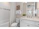 Well-designed bathroom featuring a tub, decorative basket, and a sink with quartz countertops at 1811 Spring Shower Cir, Kissimmee, FL 34744