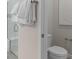 Well-lit bathroom with a glass-enclosed shower, toilet, and white towels on a towel rack at 1811 Spring Shower Cir, Kissimmee, FL 34744